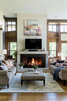 a living room filled with furniture and a flat screen tv mounted above a fire place