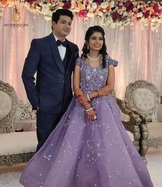 two people standing next to each other in formal wear