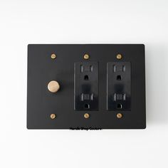 two black electrical outlets on a white wall