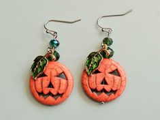 Stone earrings have been dyed orange and decorated with Czech glass beads and enamel leaves to create eye-catching Jack-O'-Lantern earrings.  HYPOALLERGENIC EAR WIRES: Gold-plated or silver-tone surgical steel or silver-tone titanium. MATERIALS USED are tarnish-resistant and durable. JEWELRY CARE QUESTIONS: Geologist here! I have a deeper understanding of most materials used in jewelry. Send ANY questions on materials or jewelry care that you have. CANCELLATIONS: Accepted within 24 hours of purc Novelty Orange Earrings For Halloween, Green Novelty Earrings For Halloween, Orange Novelty Halloween Jewelry, Nickel Free Orange Halloween Earrings, Nickel-free Orange Earrings For Halloween, Halloween Orange Nickel-free Earrings, Orange Dangle Earrings For Halloween, Orange Nickel-free Earrings For Halloween, Green Halloween Dangle Earrings