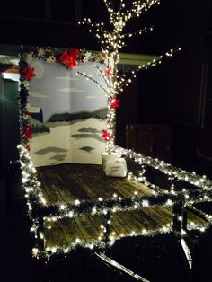 a bed covered in christmas lights and decorations