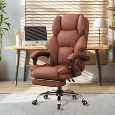 a brown office chair sitting in front of a desk with a laptop computer on it