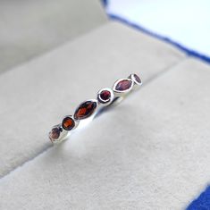 Tiny delicate vintage art deco garnet wedding ring, Small & dainty sterling silver marquise cut garnet womens wedding band, Garnet jewelry ------------------------------------------------------------------------------------------------------------------------------------------------------------------------------------------------------------- Garnet Wedding Ring ◈ Item Details ◈ Metal : Sterling Silver Metal Purity: 925 Parts Per 1000 Style : Vintage Ring Main Stone : Natural Garnet  Stone Size : 2x4 mm Stone Shape : Marquise  Other Stone : Garnet  Occasion : Party , Anniversary , Wedding Personalization : Possible 925 sterling silver with silver/white/yellow/rose gold plated. Sent in a very elegant wedding ring box, ready for one special lady. Customization is always welcome and please fe Wedding Personalization, Garnet Wedding Rings, Garnet Wedding, Elegant Wedding Rings, Wedding Ring Box, Garnet Jewelry, Garnet Stone, Womens Wedding Bands, Marquise Cut