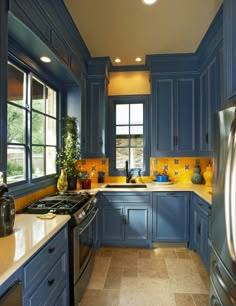 a kitchen with blue cabinets and yellow counter tops is seen in this image from the inside