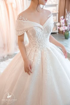 a woman in a white wedding dress looking at the camera