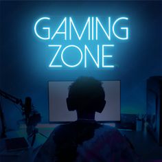 a person sitting in front of a computer with the words gaming zone written on it