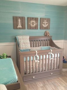 a baby's room is decorated in blue and gray