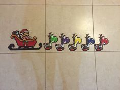 four pixelated images of santa claus and his reindeer sleigh on the floor