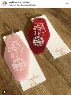 two red and pink ceramic tags on top of each other next to some white paper