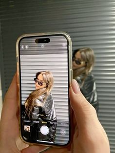 a woman taking a selfie with her cell phone