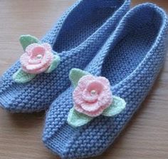 crocheted blue slippers with pink flowers on them