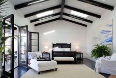 a living room filled with furniture and a white rug