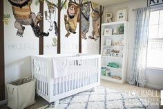 a baby's room decorated with monkeys and trees