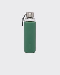 thermos bottle is green and has a metal carafe on it's side