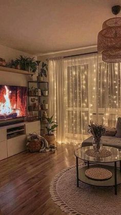 a living room filled with furniture and a flat screen tv sitting on top of a wooden floor