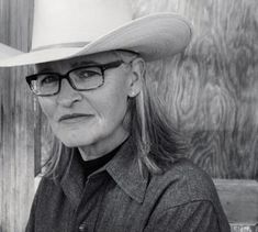 an older woman wearing a cowboy hat and glasses