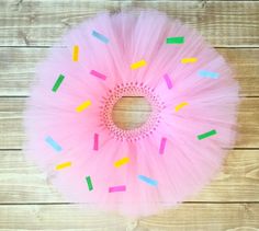 a pink tutu with colorful sprinkles and a hole in the middle