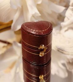 a stack of three wooden boxes sitting on top of a white cloth covered tablecloth