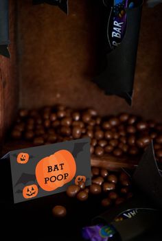 a bat poop card sitting on top of some coffee beans with bats around it