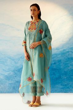 Aqua blue kurta with floral embroidered motifs in bead work and cutwork detailing. Paired with sheer hem pant with cutwork floral motifs. Comes with cotton slip.
Component: 3
Pattern: Embroidered
Type Of Work: Bead work, Floral motifs
Neckline: Round
Sleeve Type: Elbow-length
Fabric: Chanderi, Cotton
Color: Blue
Other Details: 
Side slit kurta
Scallop hem pant
Note: The dupatta worn by the model is not for sale.
Occasion: Destination Wedding - Aza Fashions Floral Dupatta, Indian Fashion Trends, Cotton Slip, Suits Design, Embroidery Suits Design, How To Hem Pants, Kurta With Pants, Embroidery Suits, Designs For Dresses