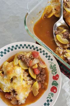 a plate of food with meat and vegetables in gravy next to a casserole dish