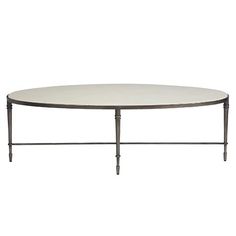 an oval table with metal legs and a white top