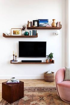 a living room with two shelves and a flat screen tv on it's wall