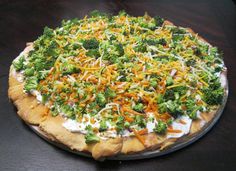 a pizza with broccoli and cheese on it