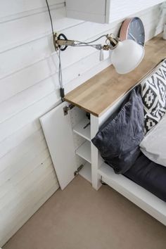 a bed with a wooden headboard and a white lamp on it's side