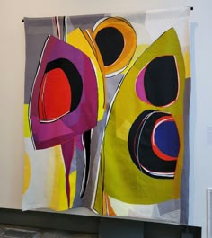 an abstract painting hanging on the wall