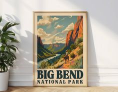 a big bend national park poster hangs on the wall next to a potted plant