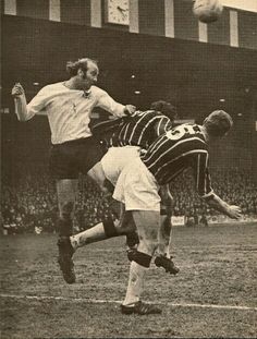 two soccer players colliding for the ball during a game