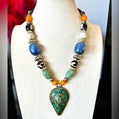 Absolutely Stunning Handcrafted Necklace, Straight From Nepal In A Mix Of Fun Beads And A Large Brass Pendant With Turquoise And Metal Bohemian Design. A Truly Unique Piece. Brand New. 21” Long Spiritual Blue Necklaces With Large Beads, Blue Spiritual Necklaces With Large Beads, Silver Beaded Necklace With Large Metal Beads, Artisan Blue Beaded Necklaces, Blue Teardrop Polished Bead Necklaces, Blue Teardrop Gemstone Bead Necklaces, Blue Teardrop Necklace With Polished Beads, Artisan Blue Necklace With Large Beads, Blue Artisan Necklace With Large Beads