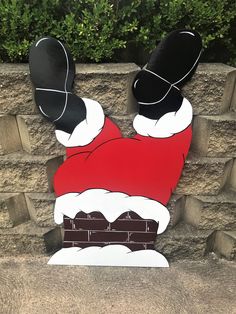 a christmas decoration made out of cardboard with santa's hat and boots on it