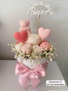 a bouquet of flowers in a heart shaped box with a cake topper on it