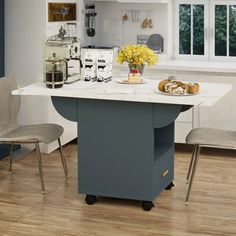 a kitchen island with two chairs next to it