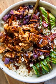 a bowl filled with rice, meat and vegetables