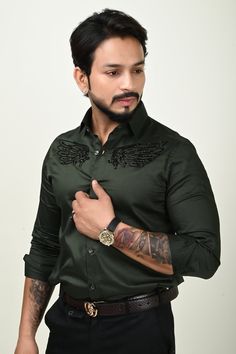 A must have designer hand embroidered bottle green shirt made in wings pattern. Flaunt the elegancy in all your parties with this designer shirt. Pair it with Black Pants to get a dapper look. Components : 1 Fabric : Giza Cotton Neckline : Straight Collar Handwork : Cutdana Work Cuff : Barrel Cuff (French cuff could also be made on request) Color : Bottle Green Other Details : Wings pattern made in cutdana work Mens Party Shirt, Shirts For Men Designer Shirts For Men Designer Casual, Formal Festive Embroidered Shirt, Festive Formal Embroidered Shirt, Designer Green Cotton Shirt, Semi-formal Green Cotton Top, Embroidered Cotton Top For Party, Festive Party Shirt With Embroidery, Festive Embroidered Party Shirt