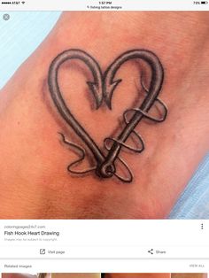 a heart with an arrow tattoo on the wrist is shown in this image, it appears to be done by someone else