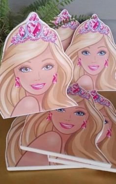 three barbie dolls with tiaras on their heads, one is blonde and the other has blue eyes