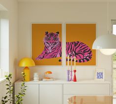 there are two paintings on the wall in this living room, one with a tiger