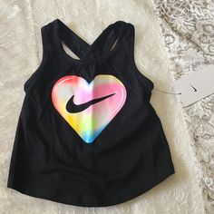 New The Nike Tank Is Sure To Be A Flowy Favorite. Featuring A Bright Graphic Print On Front And A Keyhole Detail On Back, This Tank Will Help Keep Kiddos Comfy At Play. Soft Cotton Fabric Feels Comfortable And Lightweight. Standard Fit For A Relaxed, Easy Feel. 100% Cotton Black Summer Playwear Tops, Sporty Tops For Summer Playtime, Black Cotton Tops For Playwear, Trendy Letter Print Tops For Playtime, Multicolor Graphic Print Tops For Playwear, Playful Black T-shirt For Spring, Black Spring Playwear Tops, Nike Playful Tops, Playful Nike Tops For Playtime