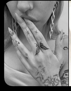 two women with tattoos on their hands and fingers