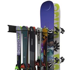 there are many skis and snowboards on the rack