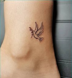 a small bird tattoo on the side of a woman's lower back leg and foot