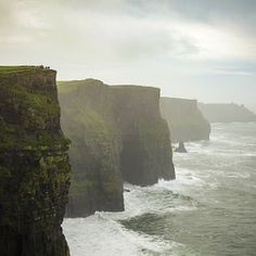 cliffs on the coast line with waves crashing against them