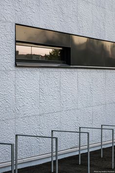 a white building with windows and bars on the outside