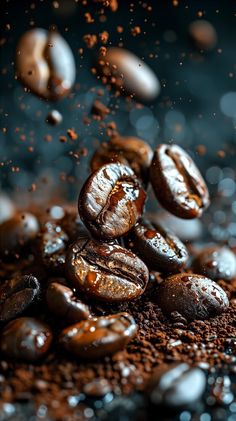 coffee beans falling down on top of each other in the middle of roasted coffee beans