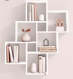 a shelf with books, vase and other items on it