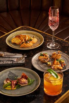 a table topped with plates and glasses filled with food